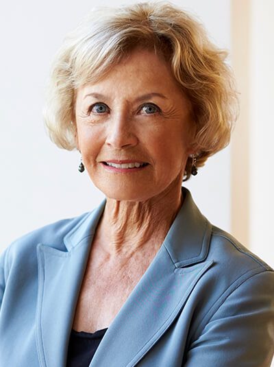 portrait-of-smiling-senior-businesswoman-in-modern-KEHVBZY.jpg